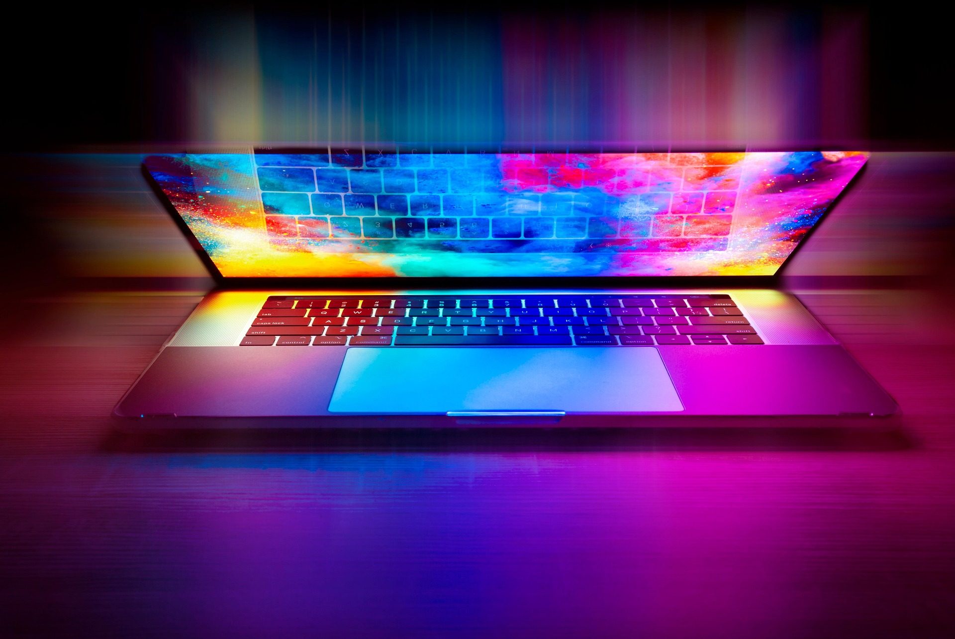 An open laptop lit in colour